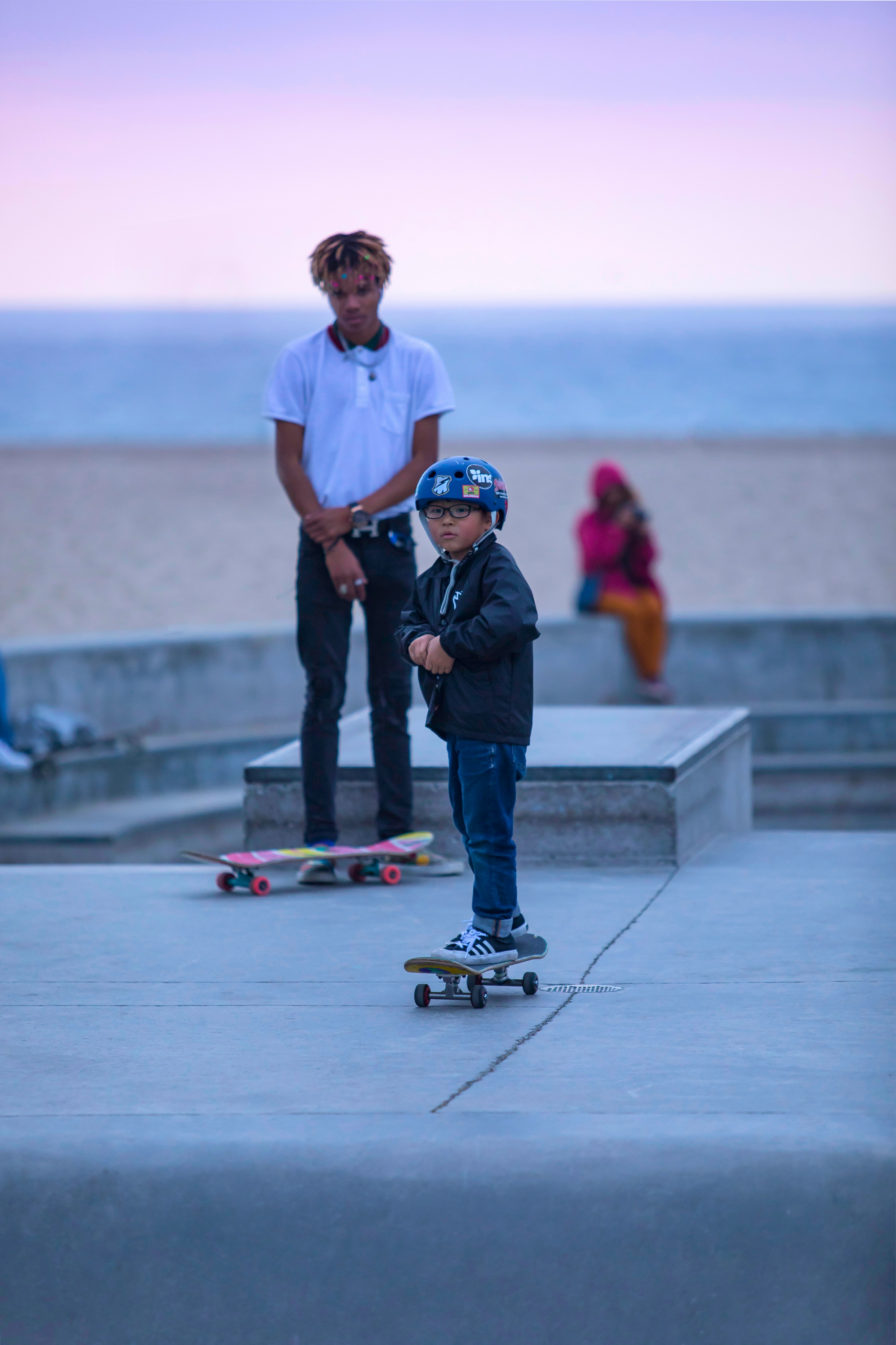 man in white t-shirt and blue denim jeans holding black and yellow skateboard